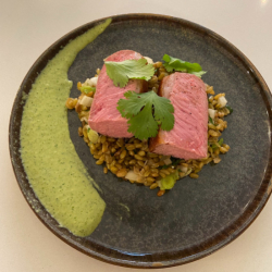 Roasted saddle of lamb, cooked freekeh, green harissa and strong juice